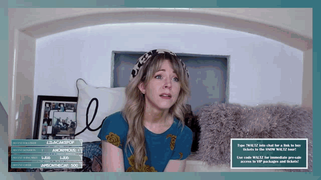 a woman in a blue shirt is sitting on a bed in front of a sign that says blackjackpop