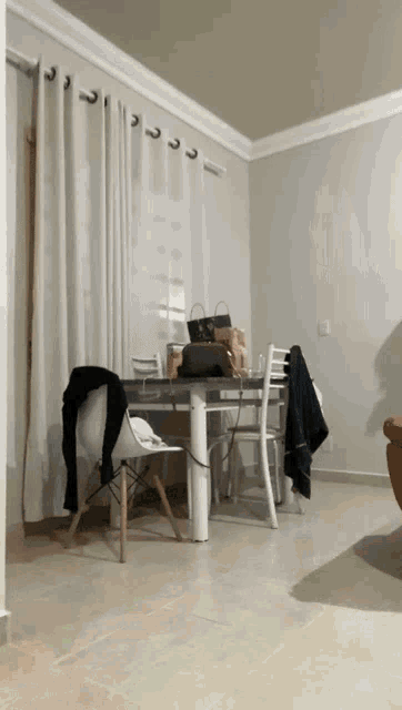 a dining room with a table and chairs and a purse on it