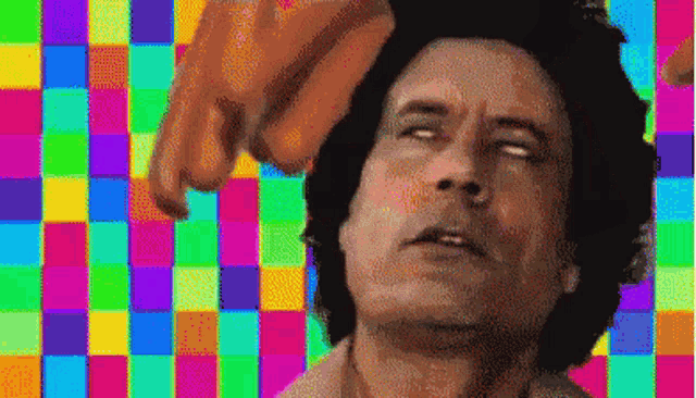 a pixelated image of a man with a colorful checkered background