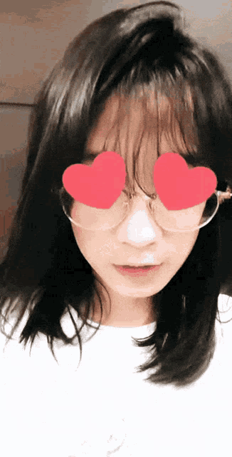 a woman wearing sunglasses with hearts in her eyes