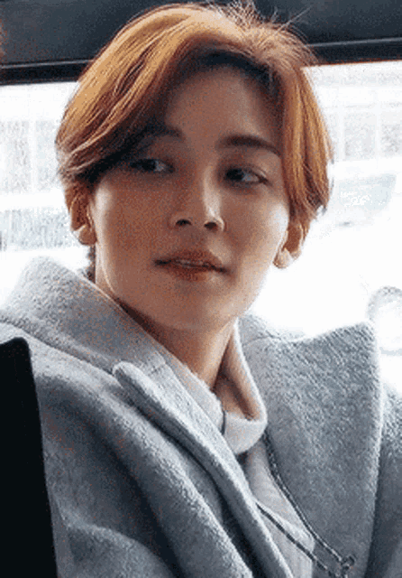 a close up of a person 's face with short hair