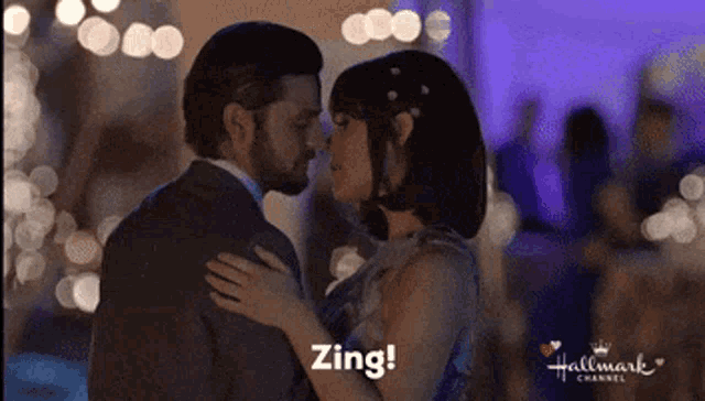 a man and a woman are kissing in a hallmark channel video