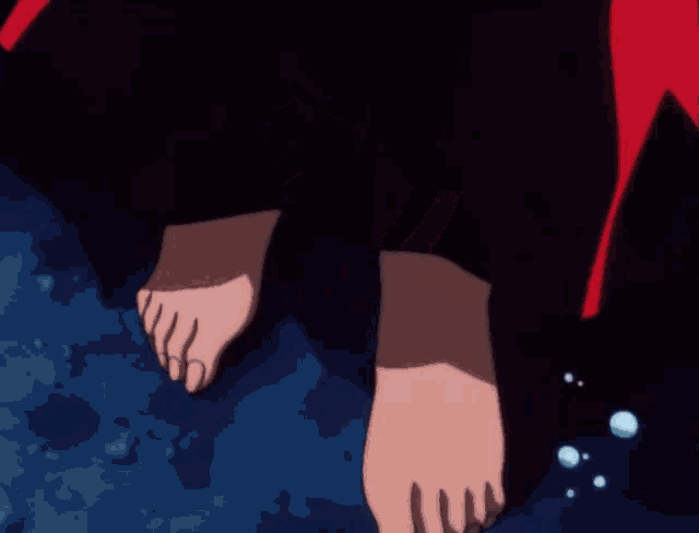 a close up of a person 's feet walking on a blue surface