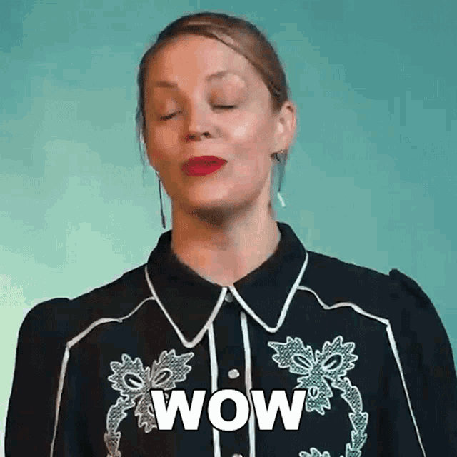 a woman in a black shirt is making a surprised face and saying wow