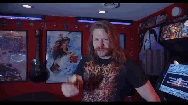 a man with long hair and a beard wearing a shirt that says ' surf '