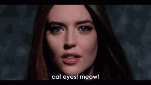 a close up of a woman 's face with the caption cat eyes meow