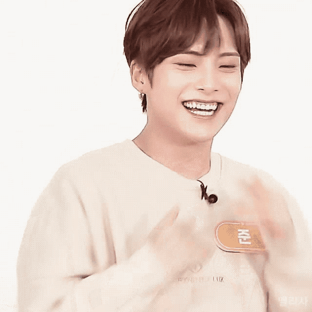 a young man is laughing with his eyes closed