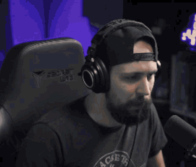 a man wearing headphones sits in a secret lite chair
