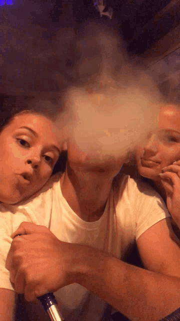 a man and a woman are smoking a hookah
