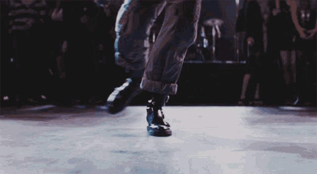 a person is dancing on a dance floor in front of a crowd of people