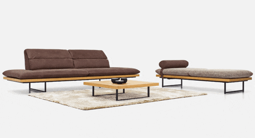 a brown couch sits next to a brown bench and a wooden coffee table
