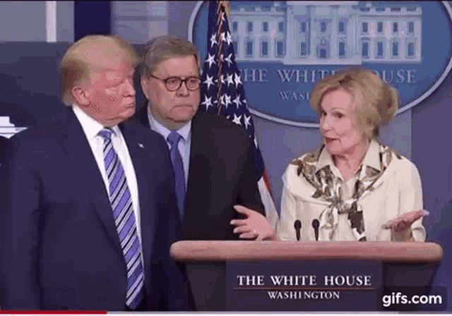 a group of people standing around a podium that says the white house washington