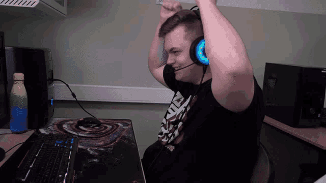 a man wearing headphones and a black shirt that says ' armour ' on it