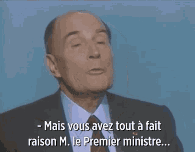 a man in a suit and tie is talking in french