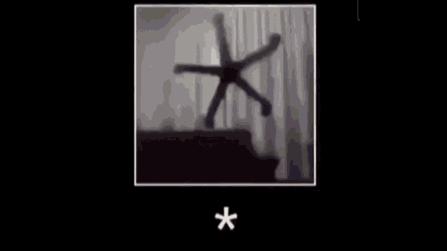a blurry picture of a person dancing in a room with curtains .