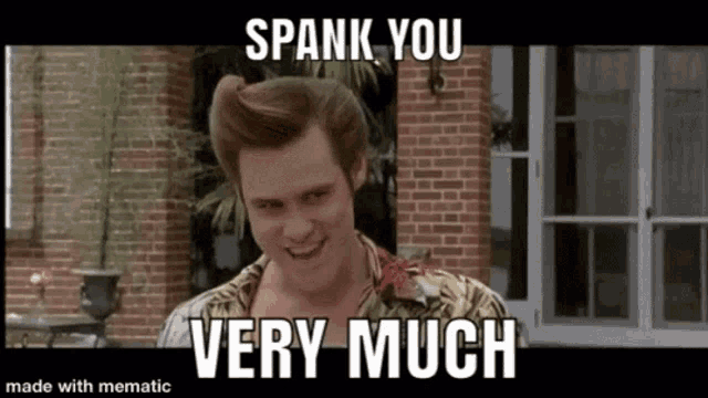 a man is standing in front of a brick building and smiling with the words `` spank you very much '' .