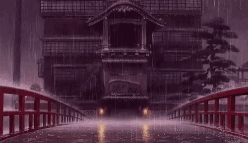 it is raining outside of a building with a bridge in the foreground .