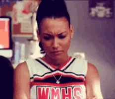 a cheerleader wearing a wmhs uniform is making a face .