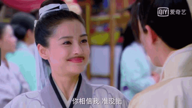 a man and a woman are looking at each other and the woman has a mustache on her face