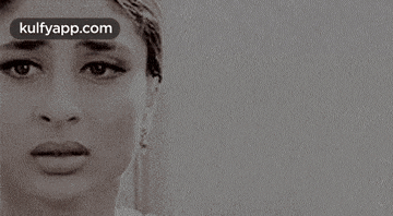 a black and white photo of a woman 's face with a serious look on her face .