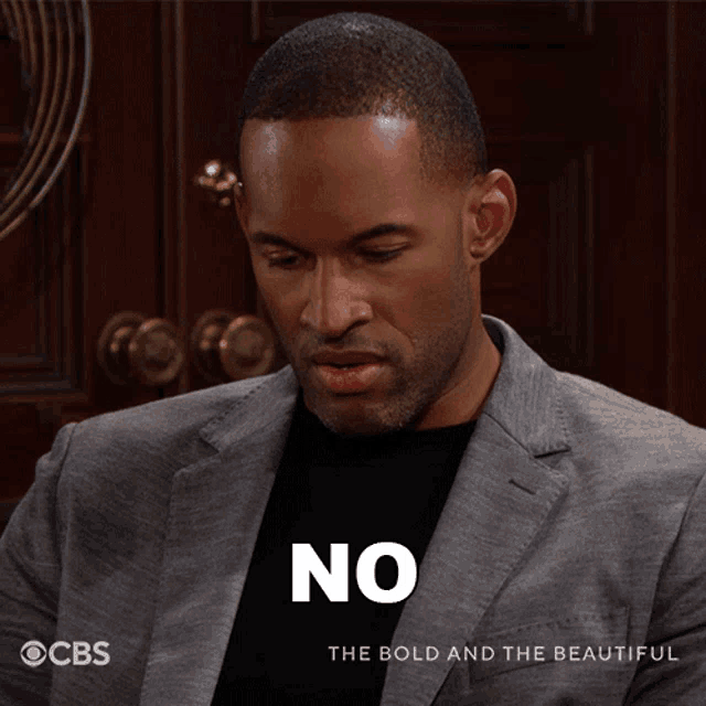 a man wearing a suit and a black shirt says no
