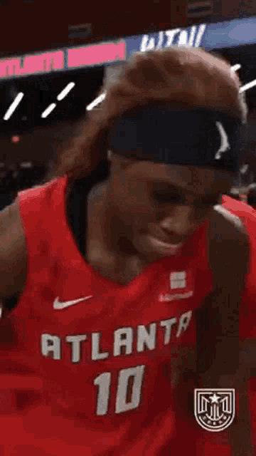 a basketball player wearing a red jersey that says atlanta 10 on it