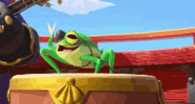a green frog is standing on top of a gold treasure chest