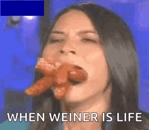 a woman is eating a sausage with the words when weiner is life written below her