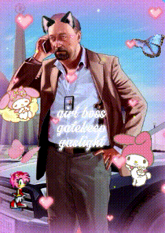 a man in a suit is talking on a cell phone with a cat ear sticker on his head