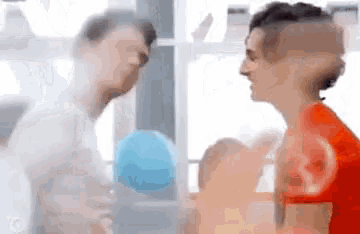 a couple of men are standing next to each other in a gym .
