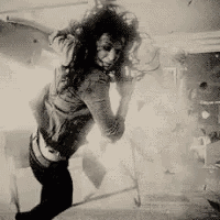 a black and white photo of a woman in a room .