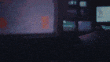 a person is playing a video game with a controller that has a circle on it