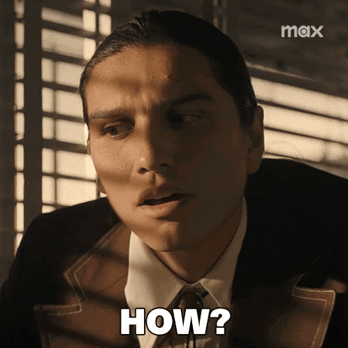 a man in a suit says how in front of a window