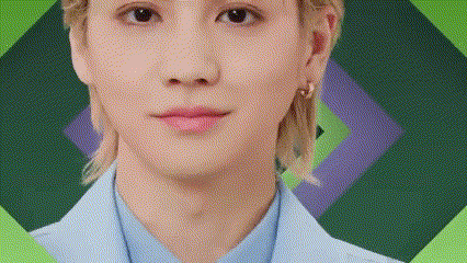 a close up of a man 's face with a green background .