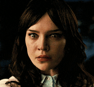 a close up of a woman with a tear running down her face