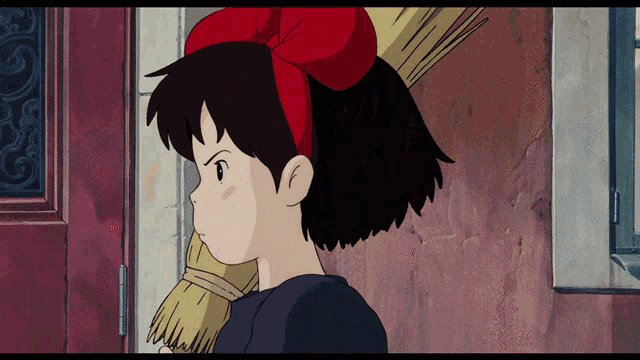 a cartoon girl with a red bow on her head holds a broom