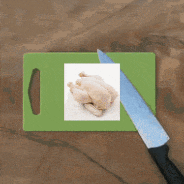 a green cutting board with a picture of a chicken and a knife on it