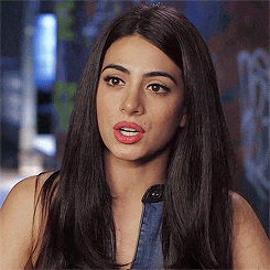 a close up of a woman 's face with long hair and red lips