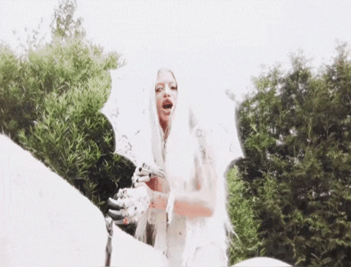 a woman with long white hair and a skeleton arm is holding a white umbrella .