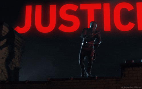 a man in a daredevil suit is jumping in front of the word justice