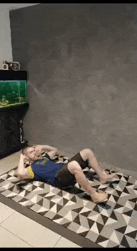 a man is doing sit ups on a rug in a room .