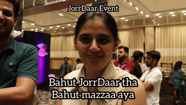 a woman is smiling in front of a group of people and the caption says jorrdaar event