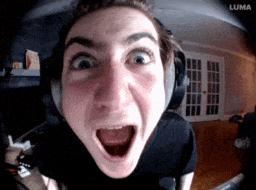 a man wearing headphones is making a funny face with the luma logo in the corner