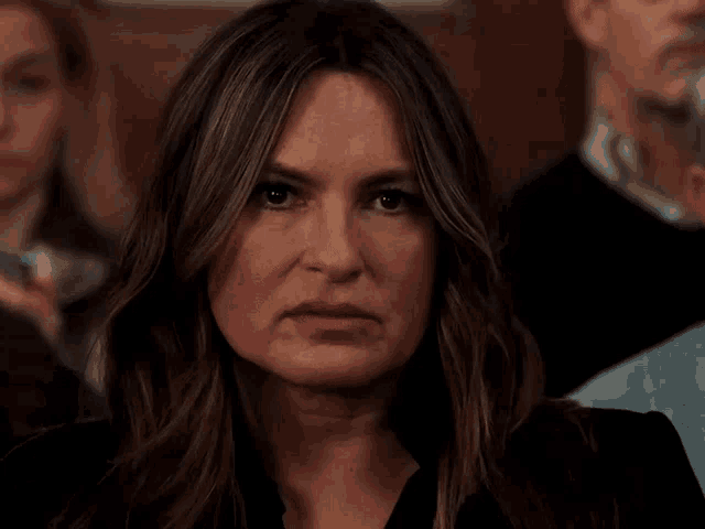 a close up of a woman 's face with a serious expression