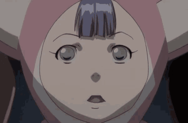 a close up of a person 's face with a surprised look on her face