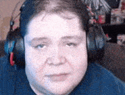 a man wearing headphones is making a funny face .