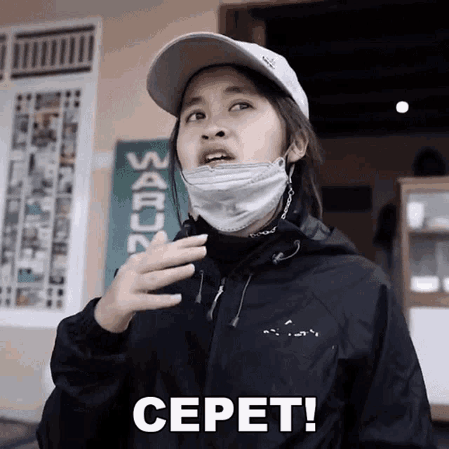 a woman wearing a mask and a hat has the word cepet on her chest