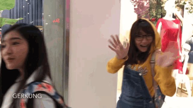 a girl wearing overalls and a hoodie with the word gerkung on the bottom