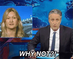 a man in a suit and tie says why not while a woman looks on