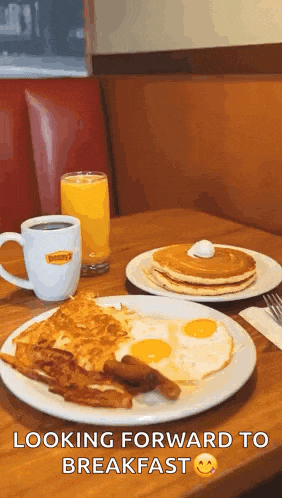 a table topped with plates of food including pancakes eggs bacon and coffee .
